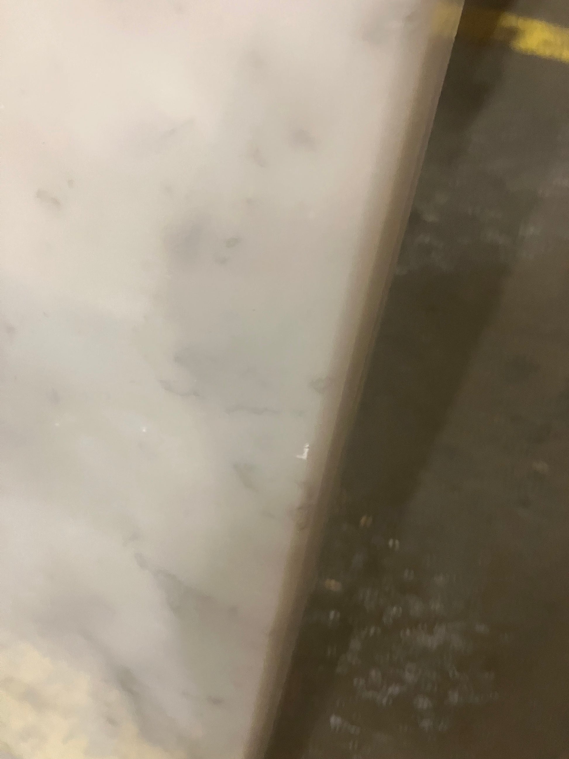 Rectangular marble dining table with four legs in Bianco Carrara White, matte finish, small edge damage visible, from My Store.