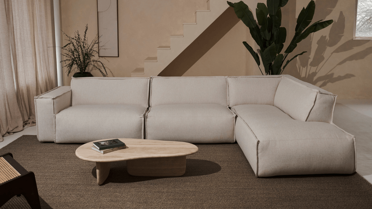 Silver YUTO Sofa Capucine longchair left in a modern living room, featuring plush cushions and sleek design.