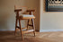 Natural rattan seat barstool Pierre by My Store, showcasing a sleek design with wooden legs and woven rattan seating.