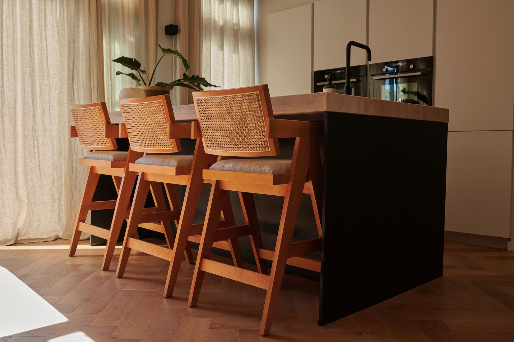 Off-white upholstered barstool with brown Pierre frame, modern design, featuring a comfortable seat and sturdy construction.