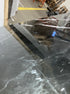 Square marble coffee table in Nero Marquina black with a glossy finish and subtle surface stains, 80x80 cm.