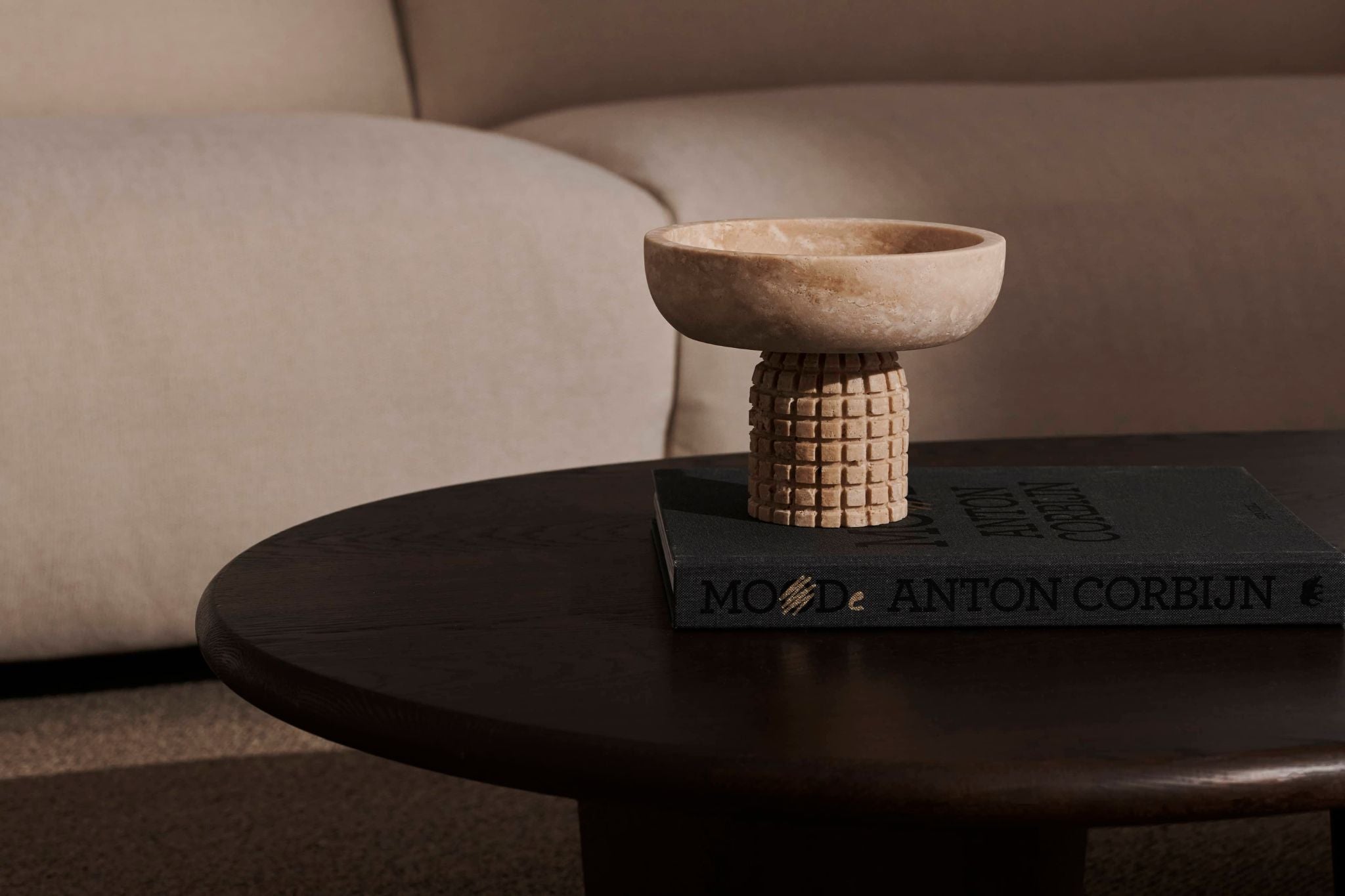 Decorative bowl from ARTIFAKT collection in travertine, showcasing natural stone texture and elegant design.
