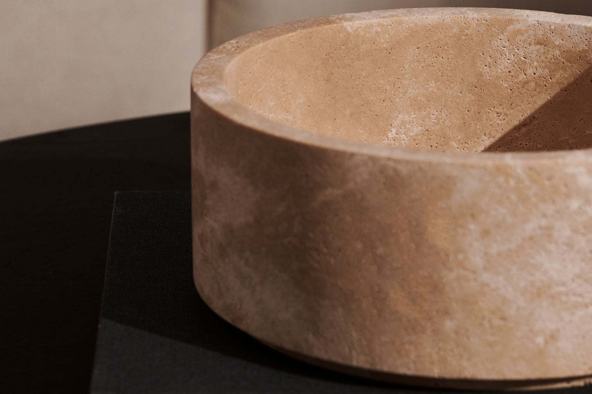 My Store ARTIFAKT collection fruit bowl made of travertine with a smooth, rounded design.