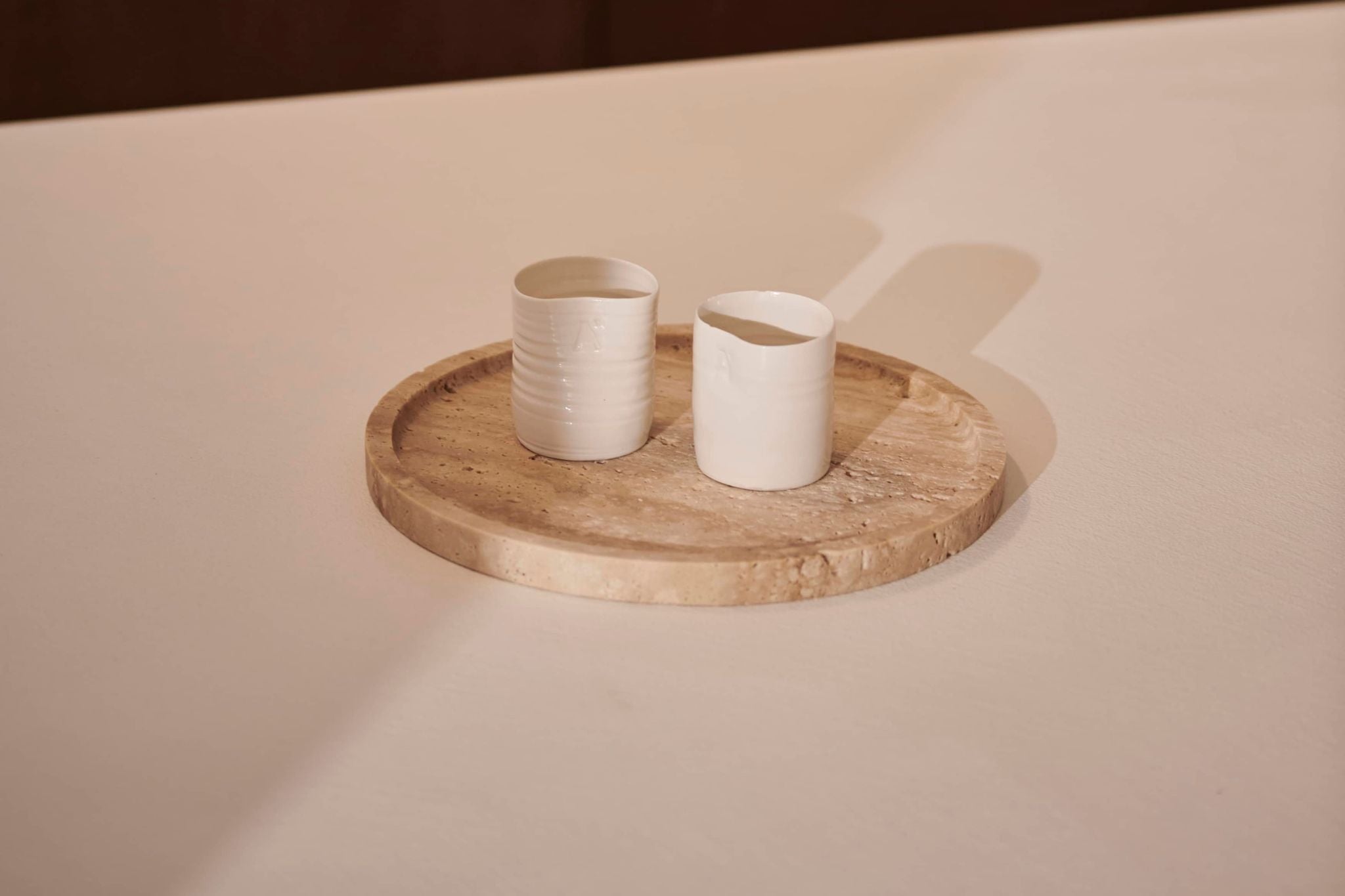 Round travertine tray from the ARTIFAKT collection, stylish and durable home decor by My Store.