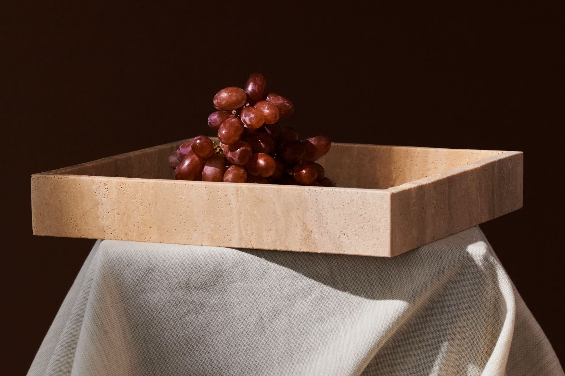 Artifakt Collection squared tray made of natural travertine with a sleek, modern design for stylish home organization.