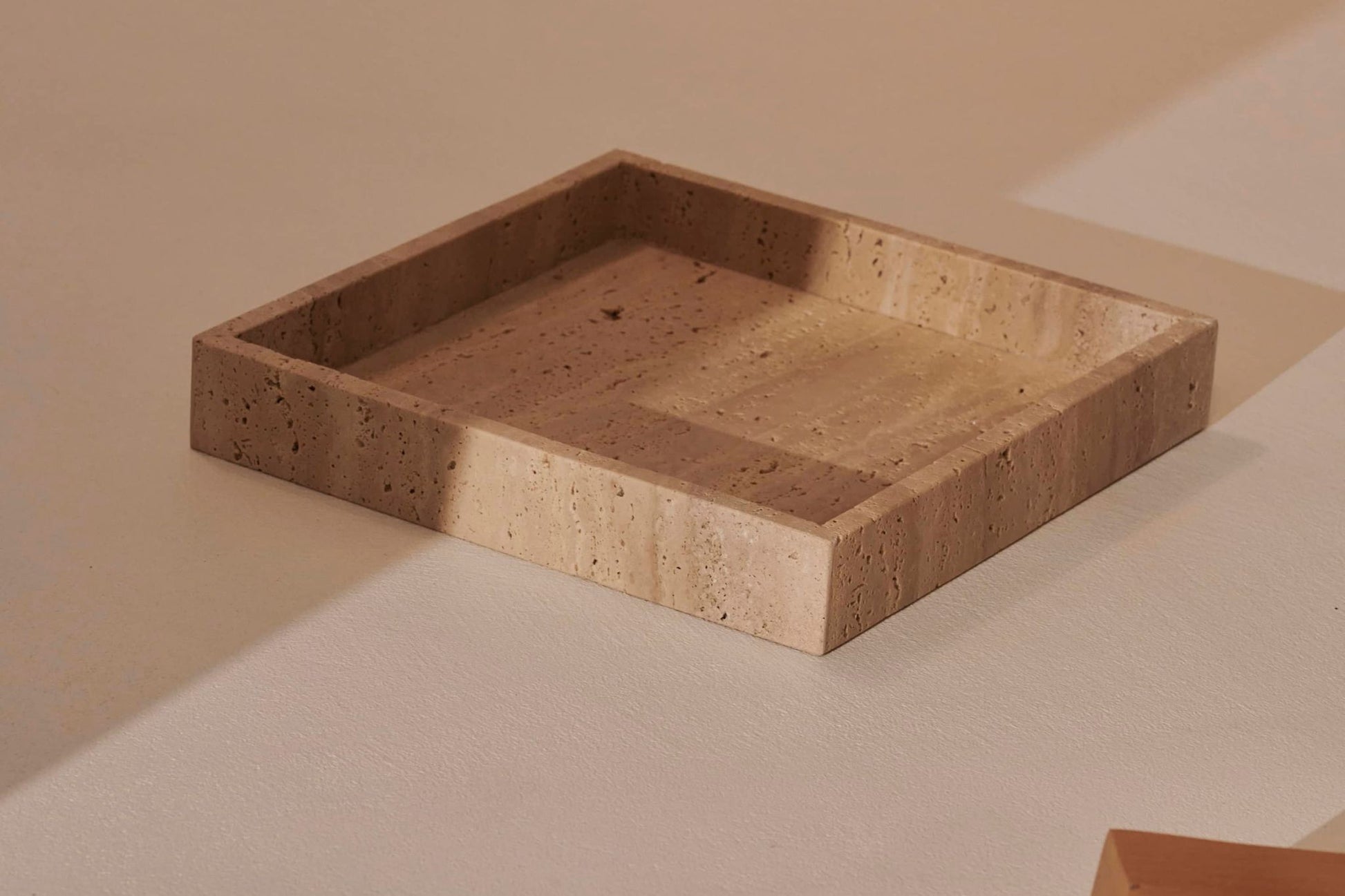 Squared tray from ARTIFAKT collection in natural travertine with clean, geometric design for stylish home decor.