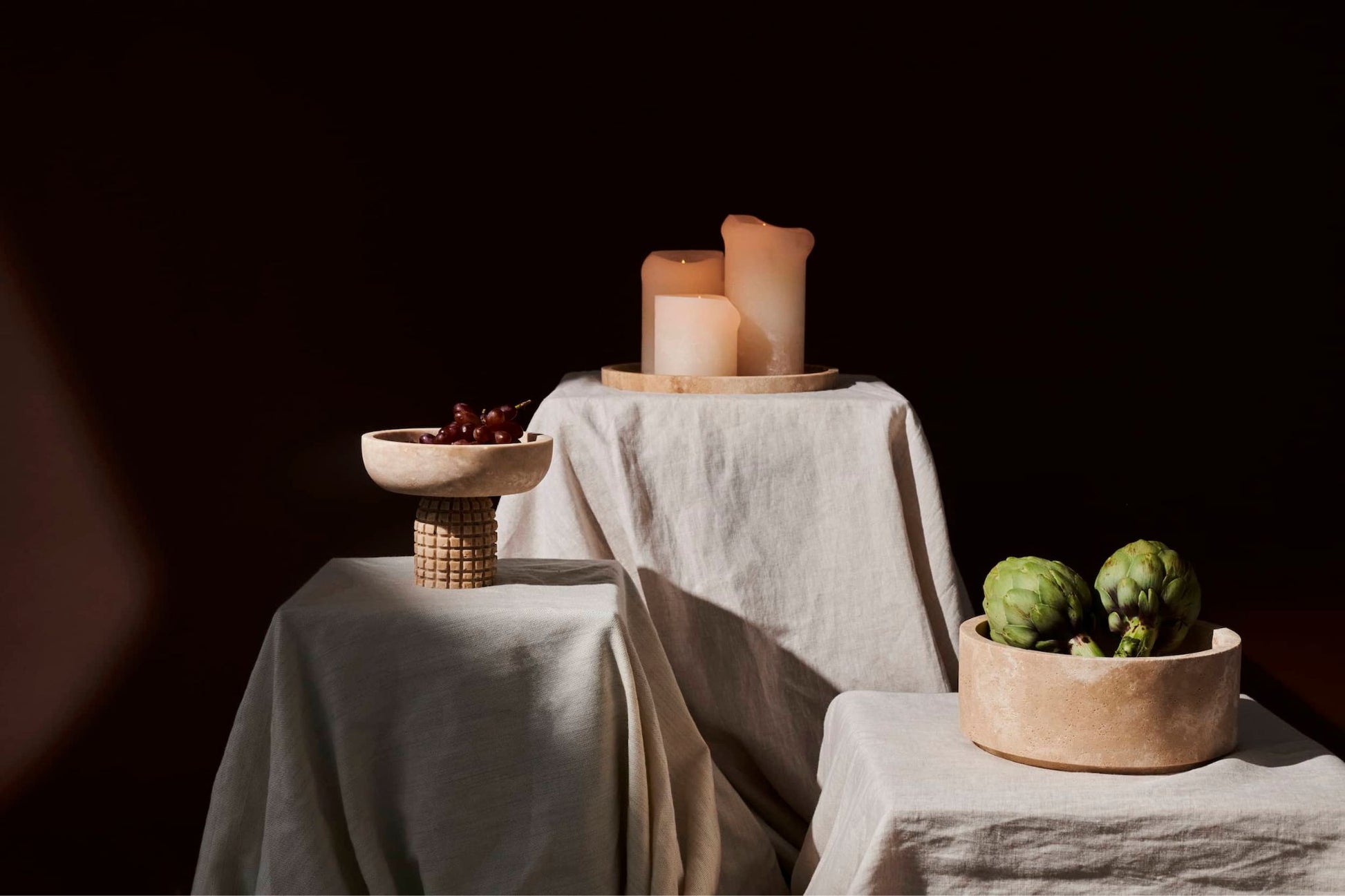 Squared tray from ARTIFAKT collection in natural travertine stone, showcasing its textured surface and modern design.