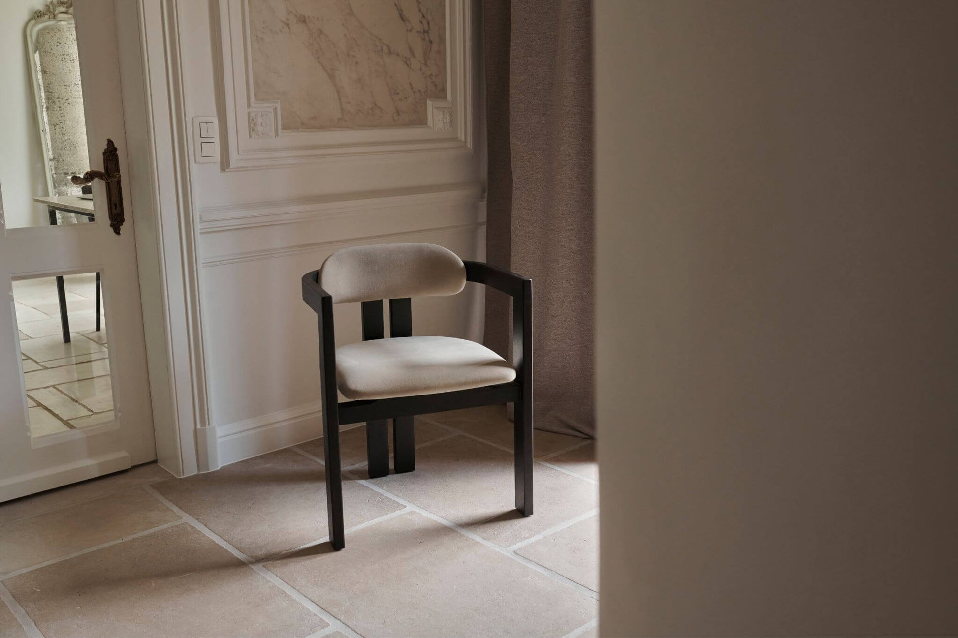 Black upholstered dining chair with liver-colored seat cushion from the Tribute collection, featuring a modern design.