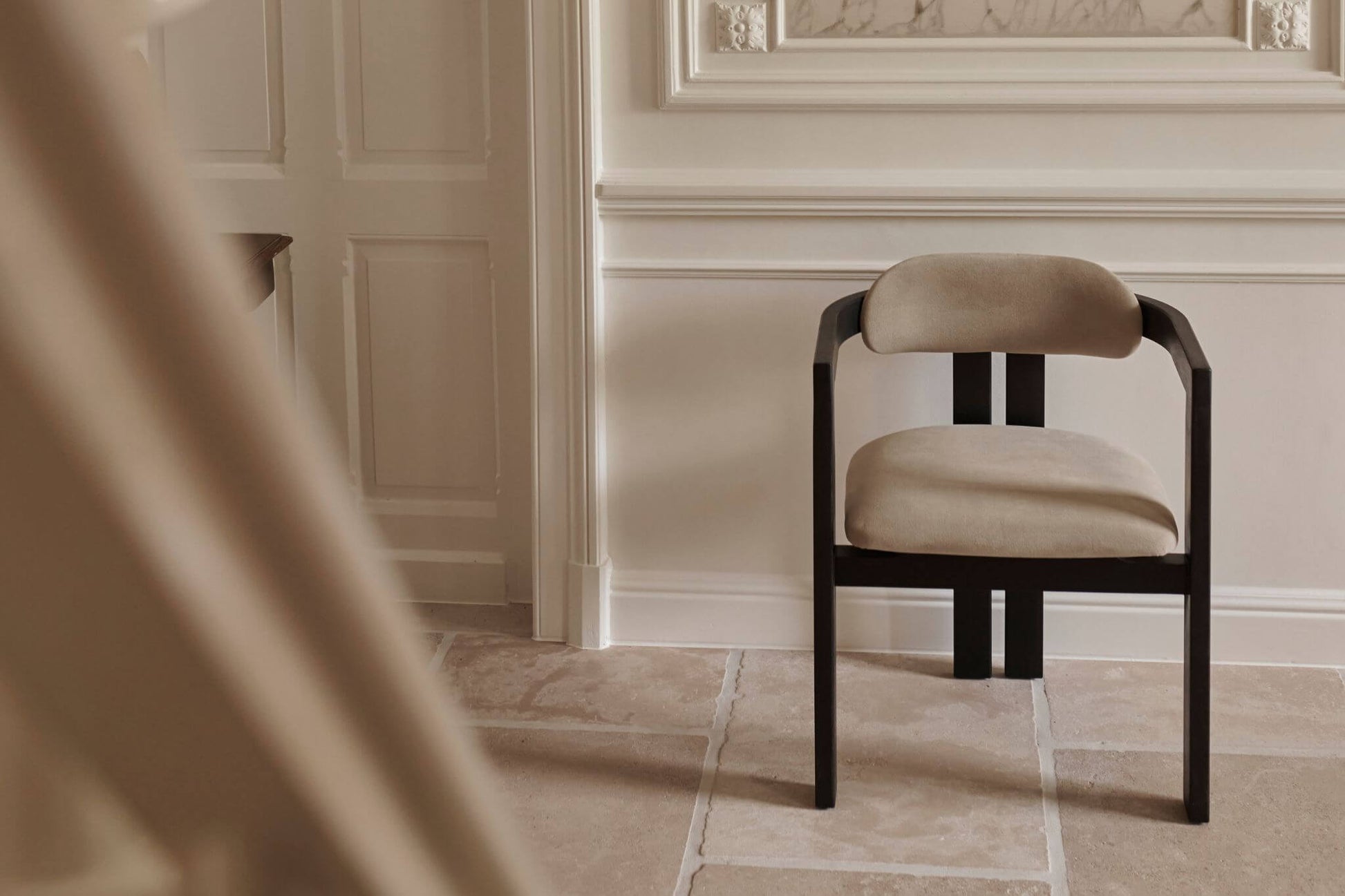 Black upholstered dining chair with a sleek design and padded seat from the TRIBUTE collection by My Store.