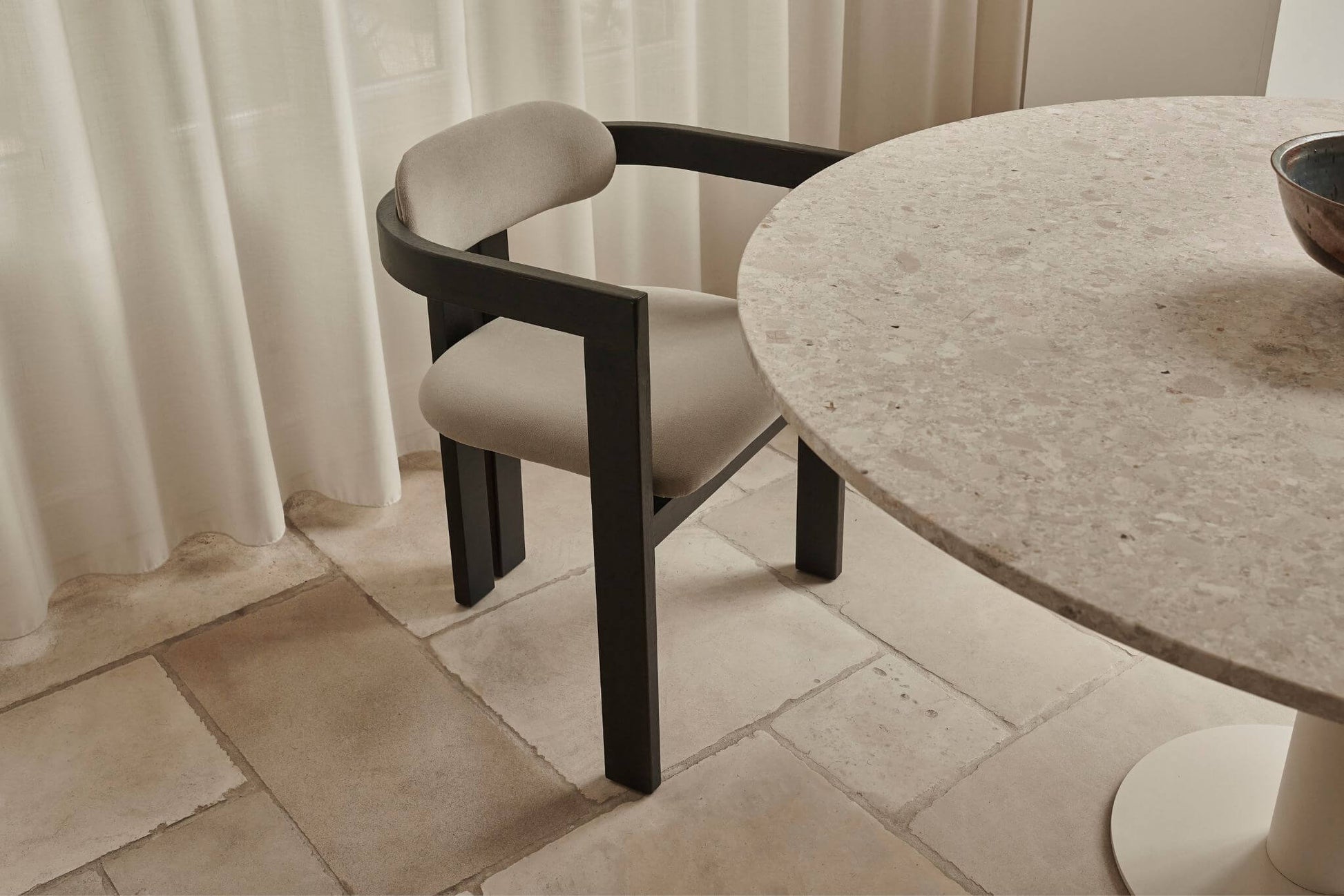 Black upholstered dining chair with liver-colored seat and modern design, part of the TRIBUTE collection.