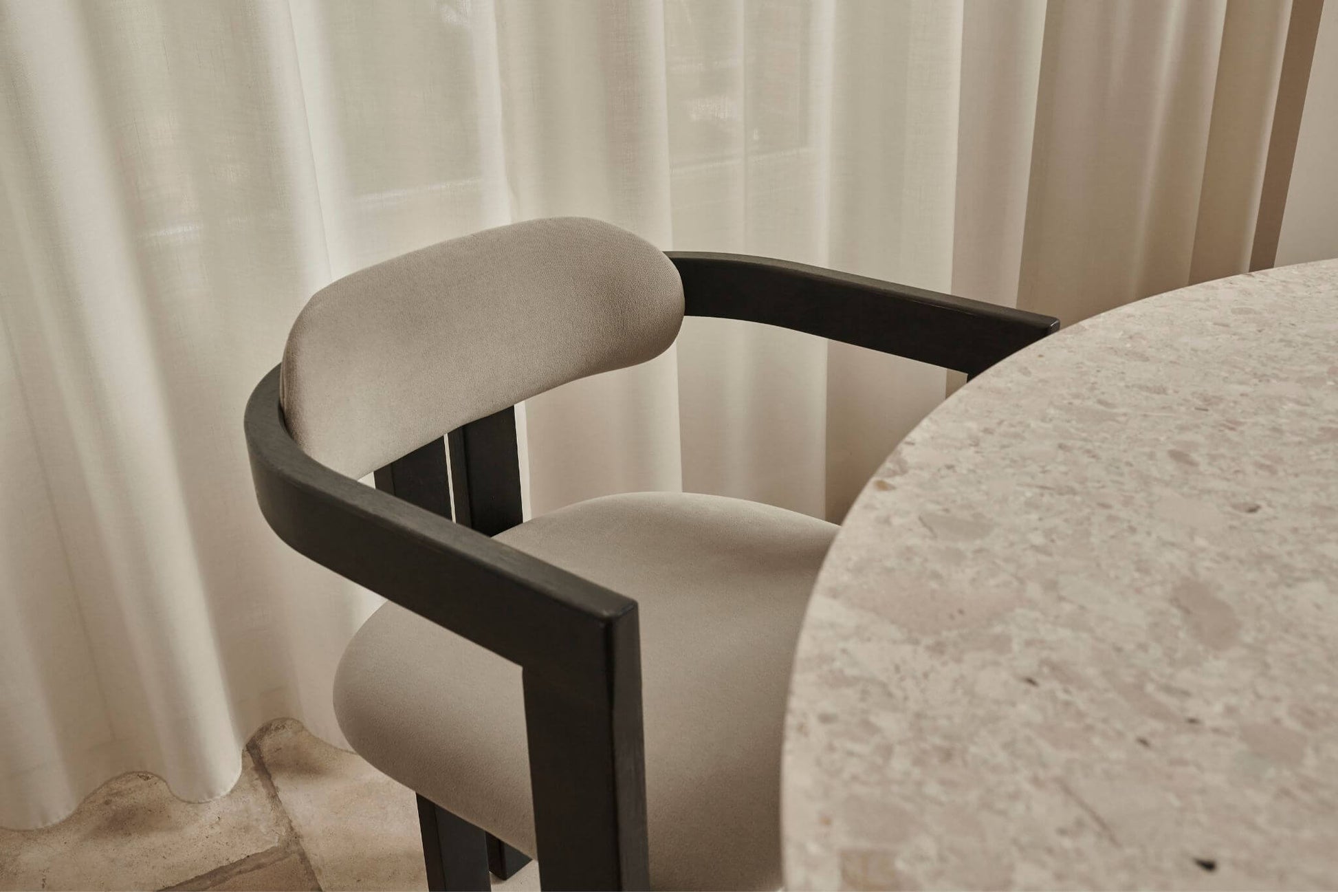 Black upholstered dining chair from the TRIBUTE collection featuring a comfortable seat and sleek design.