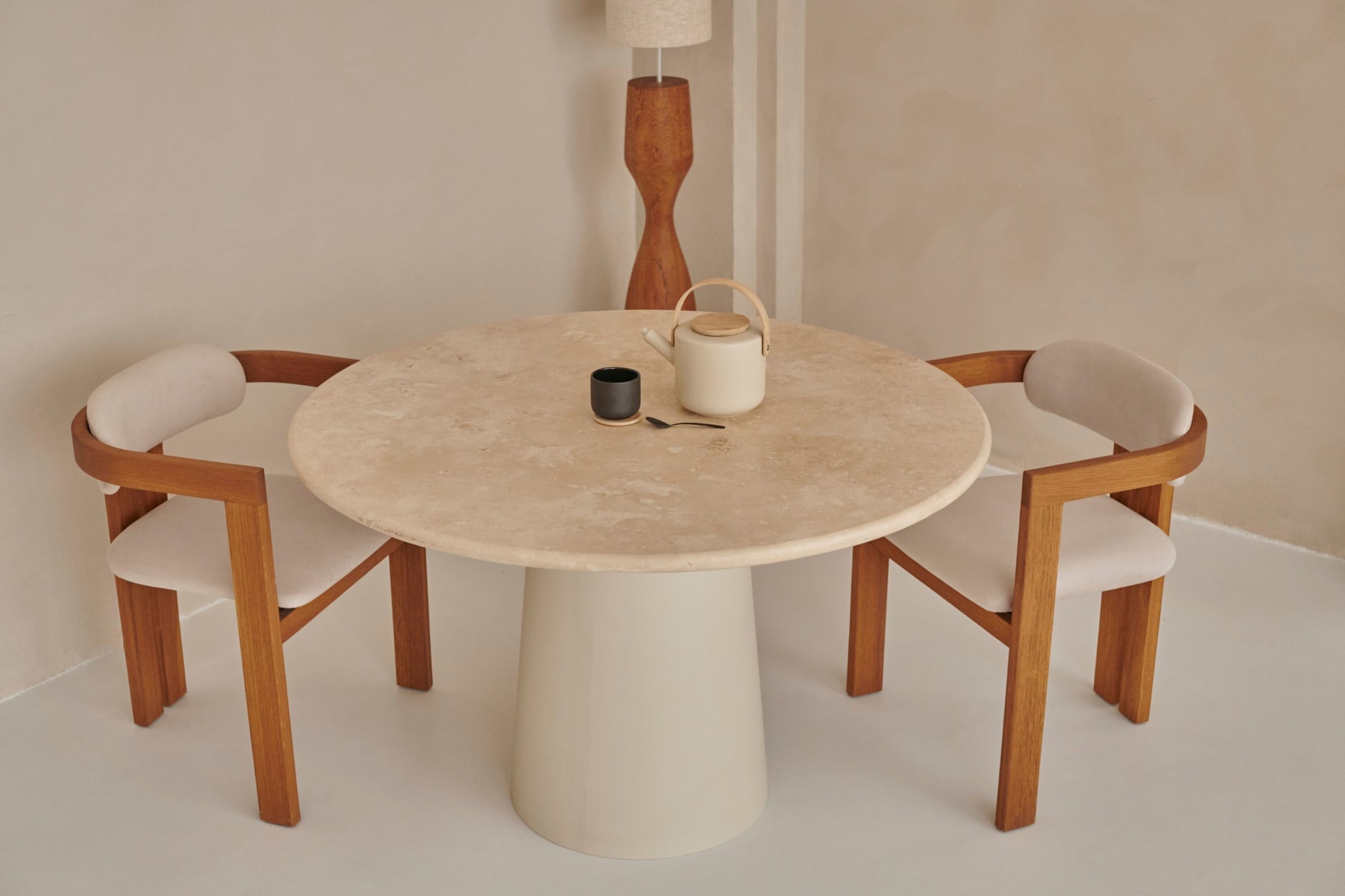 Upholstered off-white dining chair with brown wooden legs from the TRIBUTE collection, showcasing comfortable fabric seating.