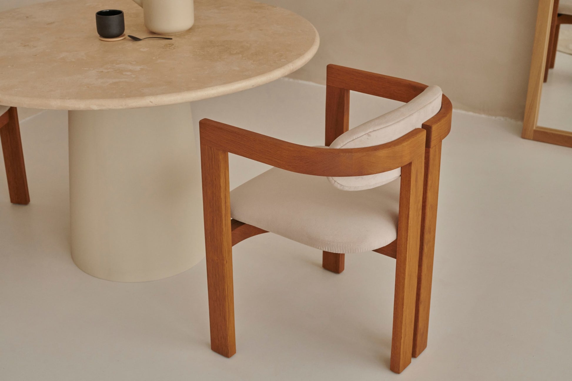 Upholstered off-white dining chair with brown legs from the TRIBUTE collection, showcasing a comfortable seat and modern design.