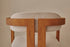 Upholstered off-white dining chair with brown legs from the TRIBUTE collection, showcasing a comfortable seat and modern design.