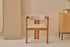 Upholstered off-white dining chair with brown legs from the TRIBUTE collection, showcasing a comfortable seat and stylish design.