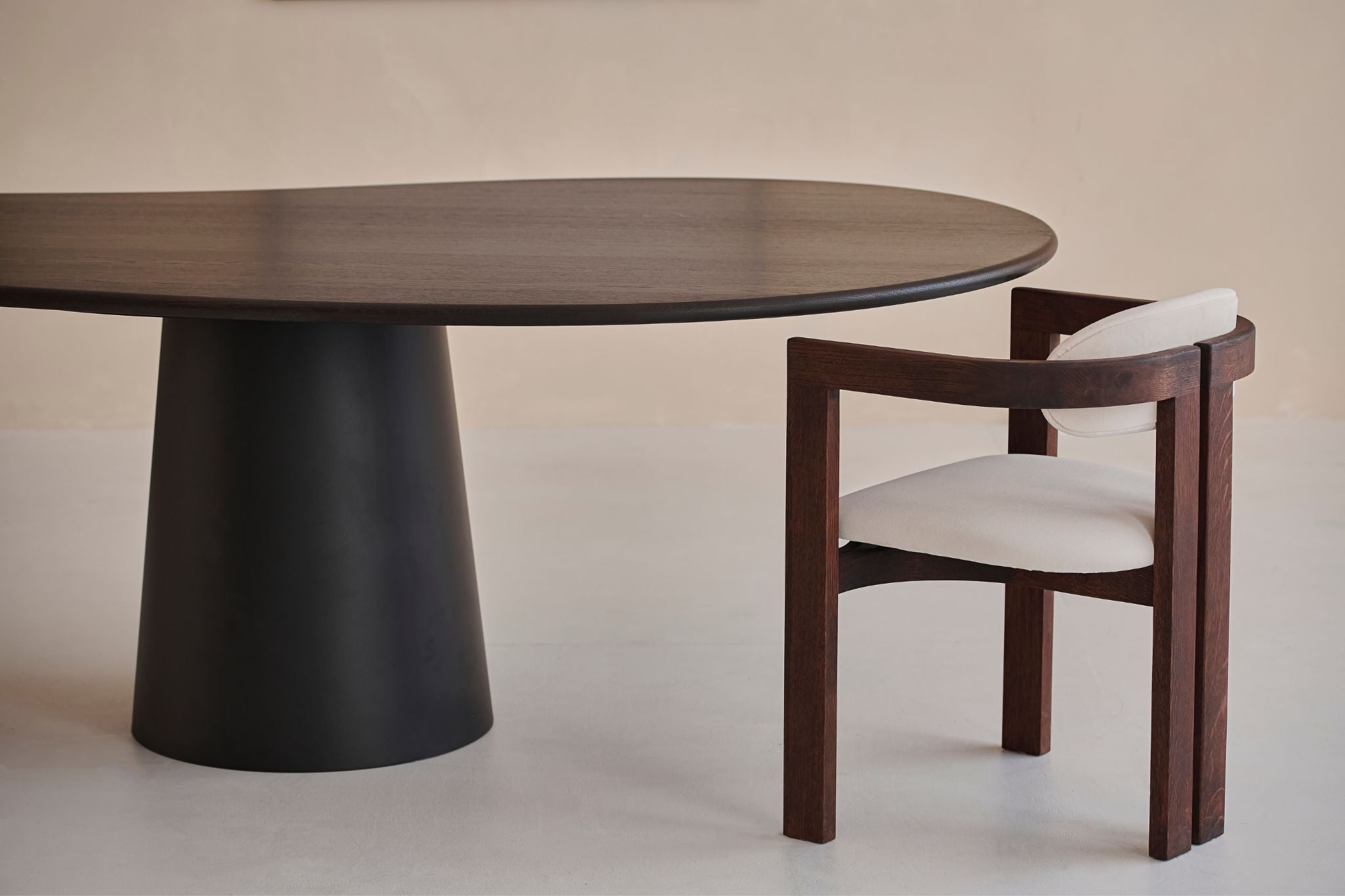 Upholstered off-white dining chair with dark brown legs from the Tribute collection, featuring a comfortable seat and modern design.