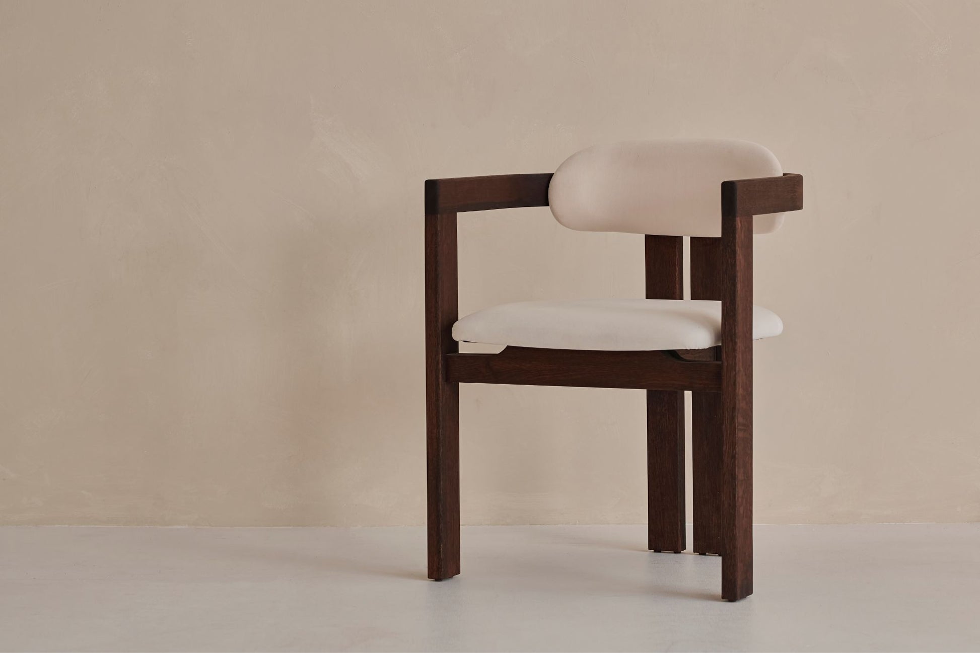 Upholstered off-white dining chair with dark brown legs, modern design, featuring a comfortable seat and sleek style.