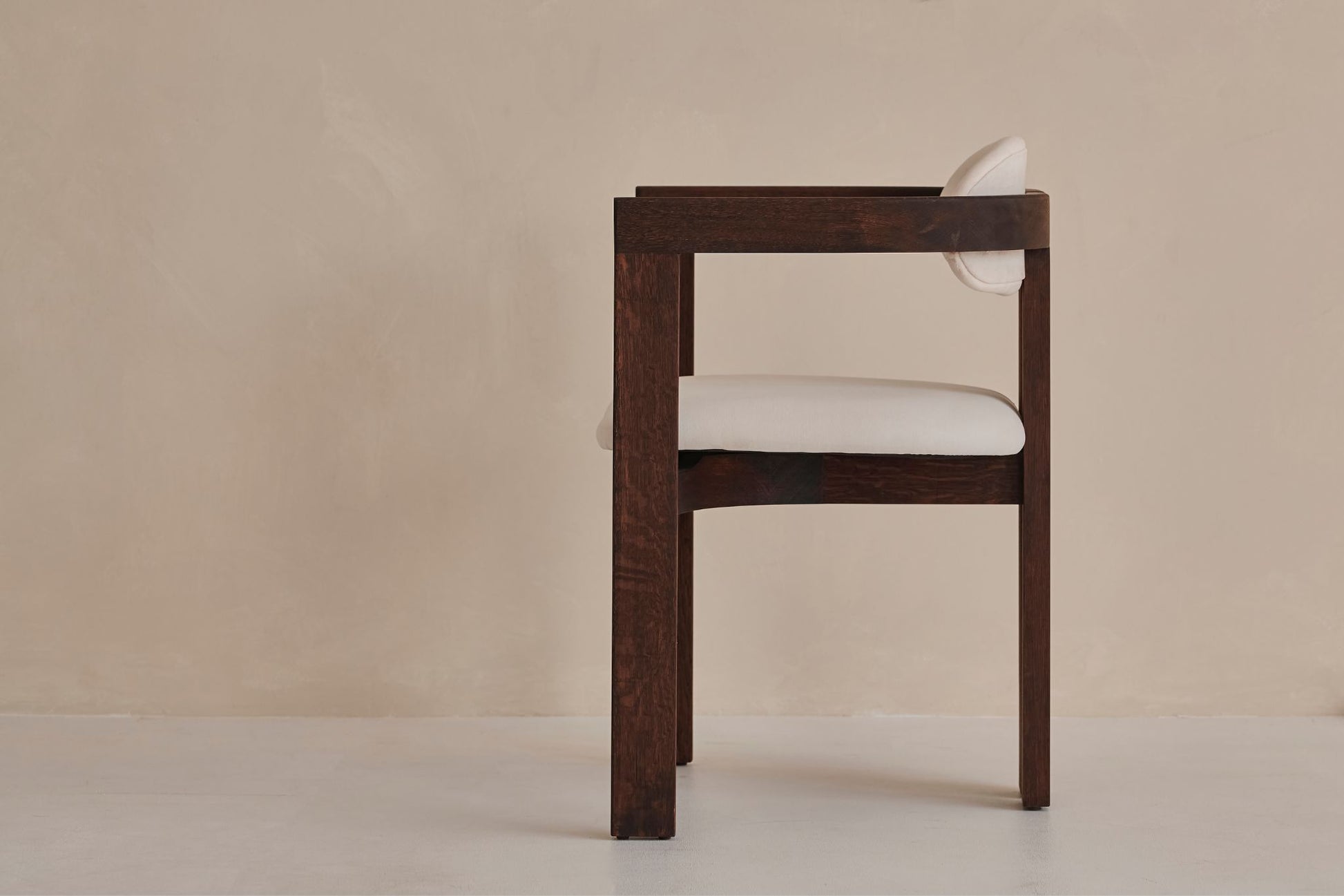 Upholstered off-white dining chair with dark brown legs from the TRIBUTE collection, showcasing a comfortable seat and elegant design.