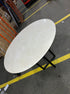 Round KIYO dining table with Crema Marfil beige marble top and wooden base, 110 cm diameter.