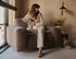Chocolate Nollie Teddy armchair by My Store featuring plush fabric and modern design, shown in a cozy living room setting.