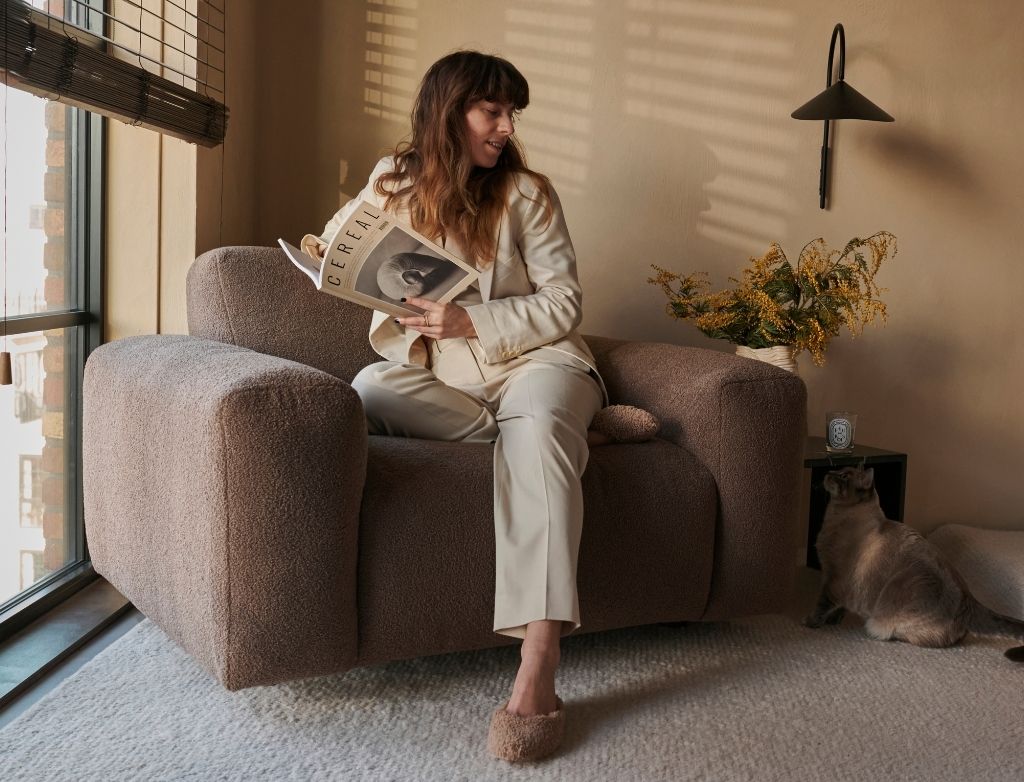 Chocolate Nollie Teddy armchair by My Store featuring plush fabric and modern design, shown in a cozy living room setting.