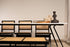 Black rattan bench named Pierre with a sturdy frame and woven seat, perfect for indoor or outdoor seating.
