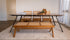 Brown rattan bench named Pierre with a sturdy frame and woven rattan seating, perfect for indoor or outdoor use.