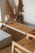 Natural rattan bench named Pierre with a woven seat and sturdy frame, ideal for indoor or outdoor seating.