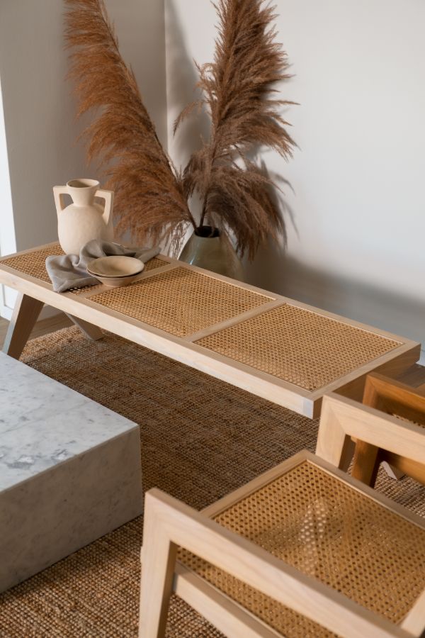 Natural rattan bench named Pierre with a woven seat and sturdy frame, ideal for indoor or outdoor seating.
