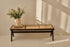 Dark brown rattan couch named Pierre with plush cushions, showcasing a stylish seating option for indoor or outdoor spaces.