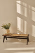 Dark brown rattan couch named Pierre with plush cushions, stylishly designed for comfortable outdoor or indoor lounging.