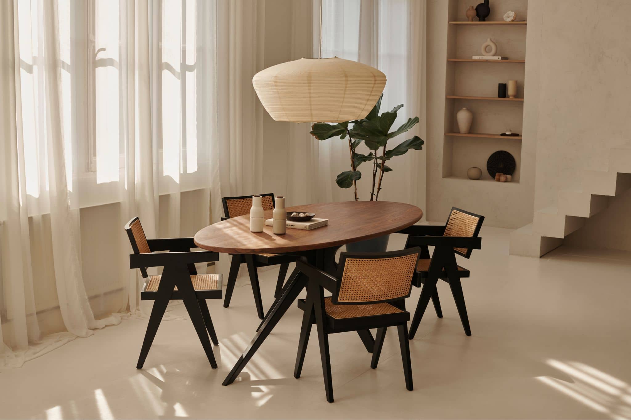 Black rattan dining chair called Pierre with a sleek design, featuring a sturdy frame and woven rattan seat for stylish dining.