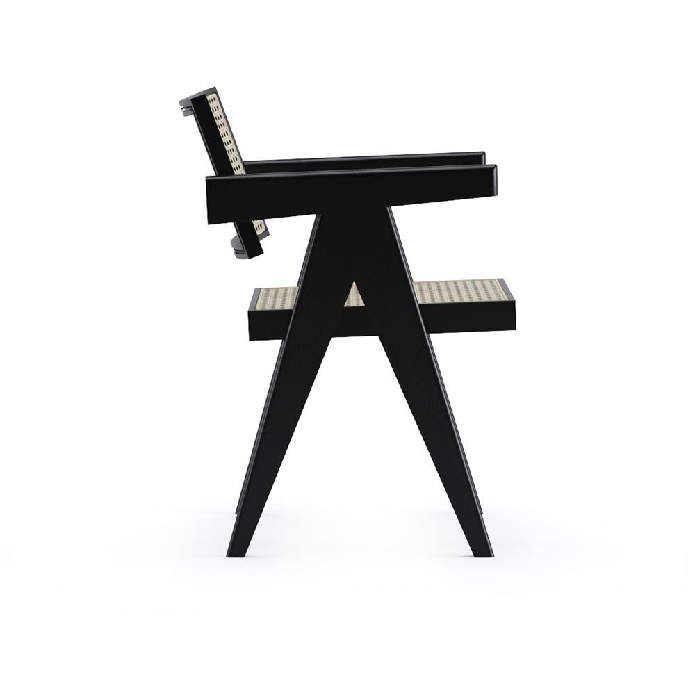Black rattan dining chair named Pierre with a woven seat and curved backrest, showcasing its stylish and modern design.
