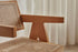Brown rattan dining chair named Pierre with a sturdy frame and woven rattan seat, perfect for modern dining spaces.