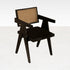 Black rattan dining chair with upholstered seat, modern design, Pierre brand, showcasing the stylish chair against a neutral background.