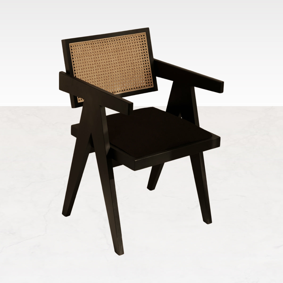 Black rattan dining chair with upholstered seat, modern design, Pierre brand, showcasing the stylish chair against a neutral background.
