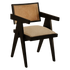Black rattan dining chair with upholstered seat named Pierre, featuring a stylish woven rattan frame and cushioned seating.