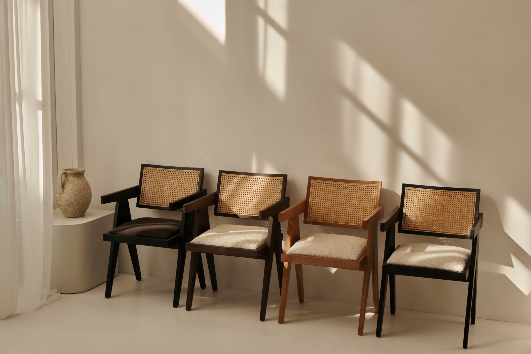 Brown rattan dining chair with upholstered seat named Pierre, featuring a stylish and comfortable design.