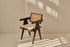 Dark brown rattan dining chair with upholstered seat, model Pierre, stylish and comfortable for modern dining rooms.