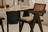 Dark brown rattan dining chair with upholstered seat, model Pierre, showcasing a stylish and comfortable design.