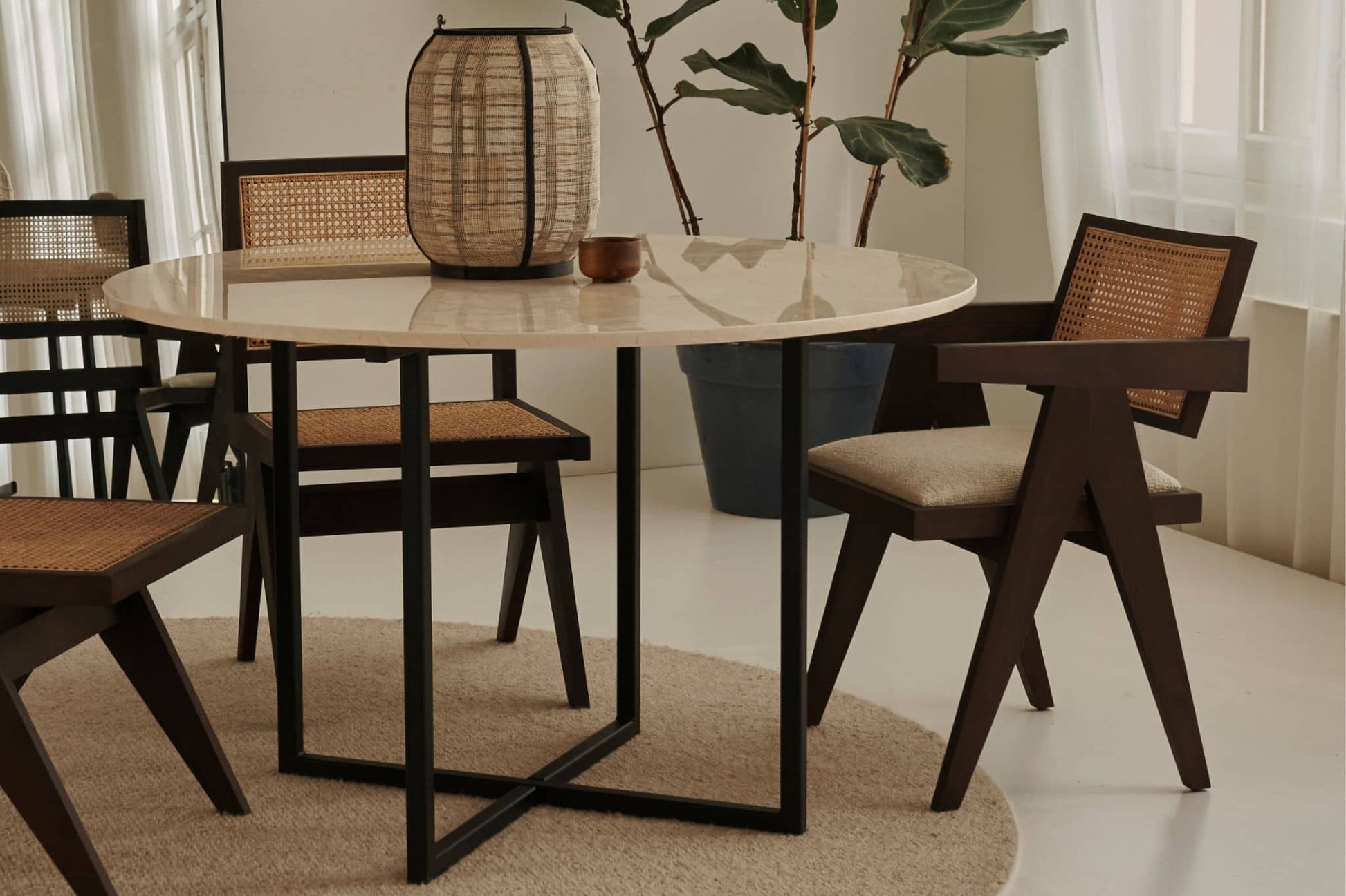 Dark brown rattan dining chair with upholstered seat, model Pierre, showcasing a stylish and comfortable design.