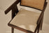 Dark brown rattan dining chair with upholstered seat, model Pierre, featuring a stylish and comfortable design.