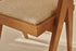 Rattan dining chair with upholstered seat and no armrests in brown, designed by Pierre for stylish comfort.