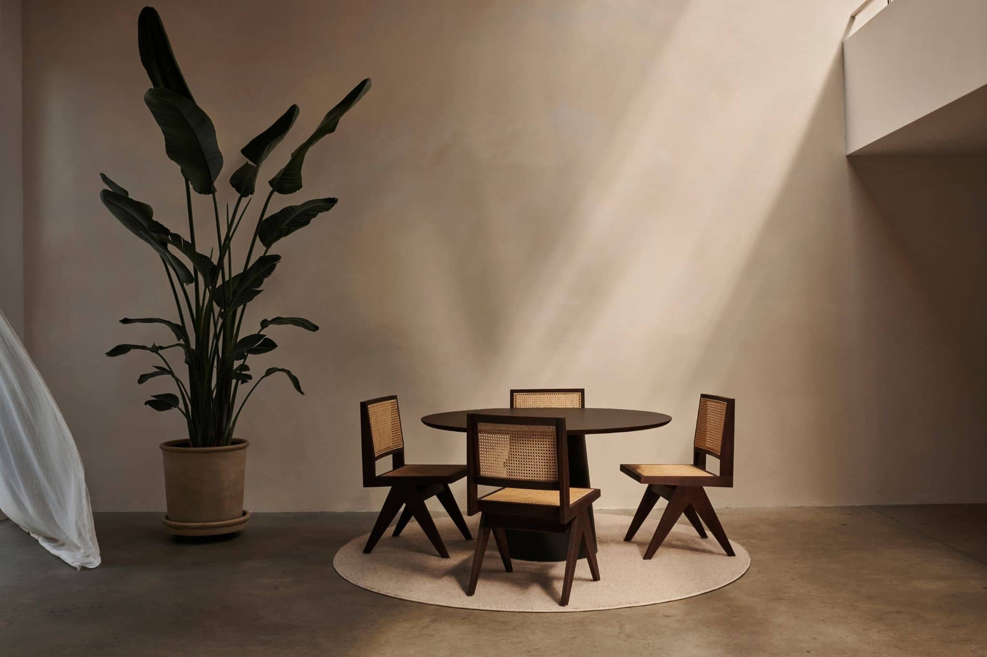 Black rattan dining chair without armrests, Pierre design by My Store, featuring a sleek, modern look with woven rattan texture.