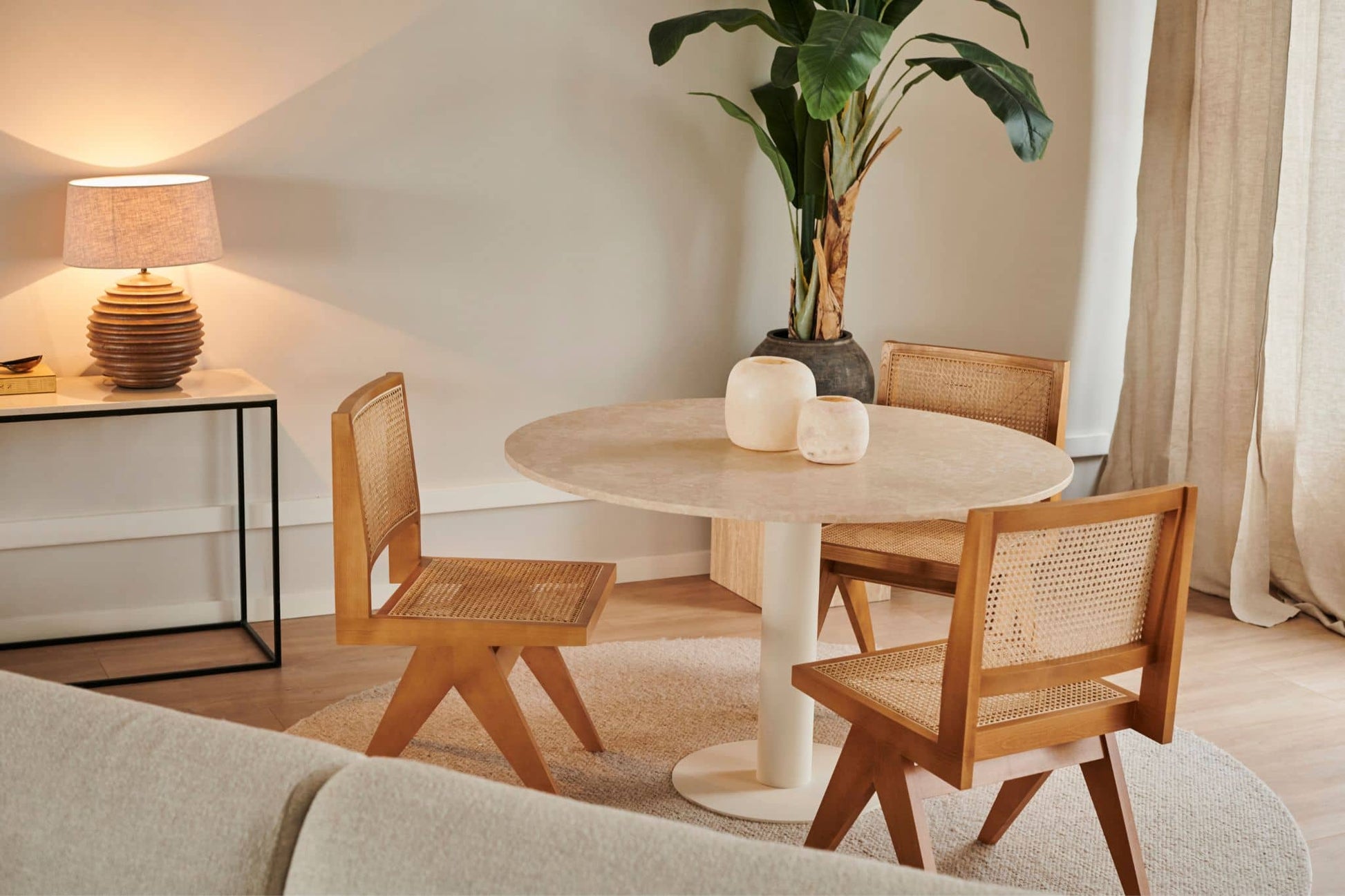 Brown rattan dining chair without armrests, model Pierre, showcasing woven rattan seat and sleek natural wood legs.