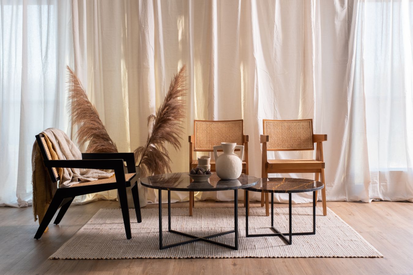 Black rattan fauteuil Pierre by My Store featuring a stylish, curved design and woven rattan construction for comfortable outdoor seating.