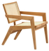 Brown rattan fauteuil named Pierre featuring a cozy, woven design with a sturdy frame, perfect for stylish seating.