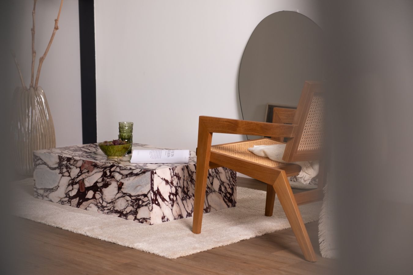 Dark brown rattan fauteuil called Pierre with a modern design, showcasing woven rattan material and a comfortable seating structure.