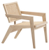 Natural rattan fauteuil chair named Pierre with a woven design, showcasing its elegant curved frame and light finish.