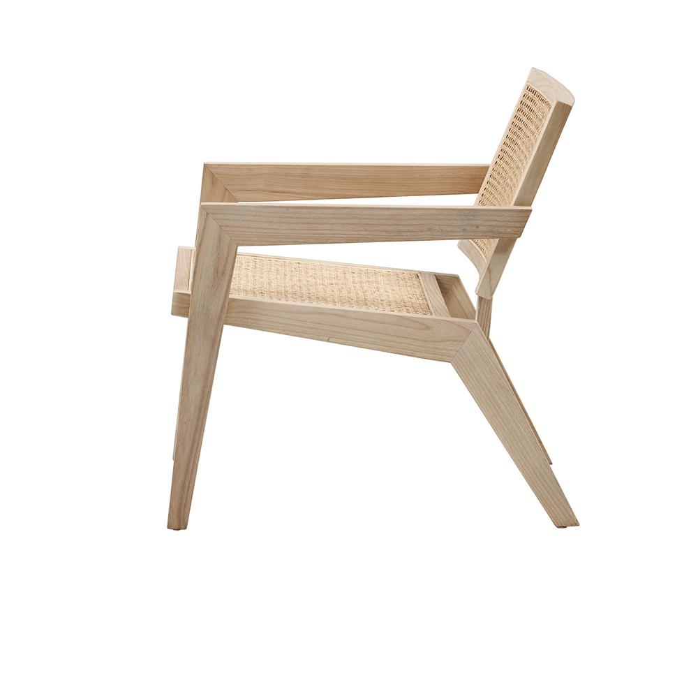 Natural rattan fauteuil named Pierre featuring a curved design and woven texture, perfect for stylish indoor or outdoor seating.